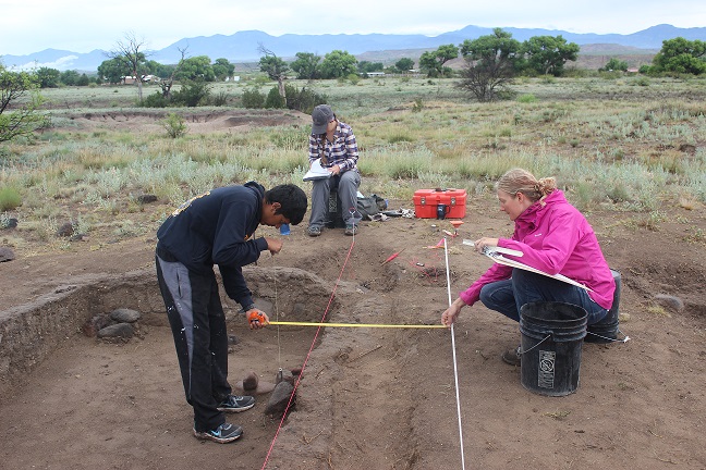 three people excavating in New Mexico