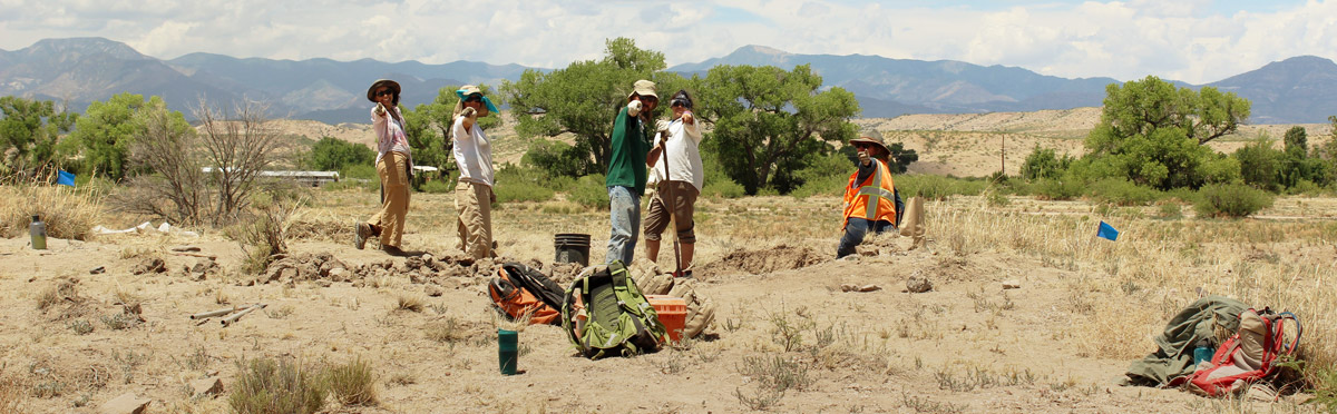 group standing at excavation site in Arizona desert landscape