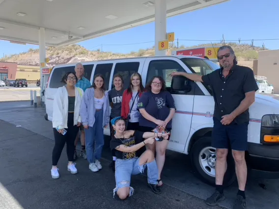 Group posing with white van