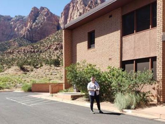 Maddie Moeller in front of a building at Zion National Park