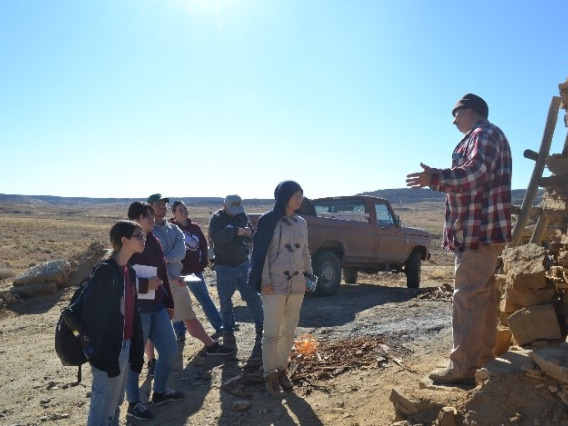 group of students facing instructor in outdoor desert landscape
