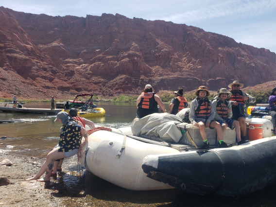 BARA members push inflatable raft into river