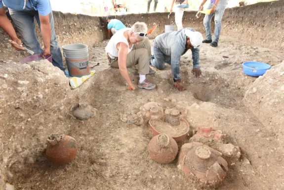 Daniela Triadan excavating a cache.