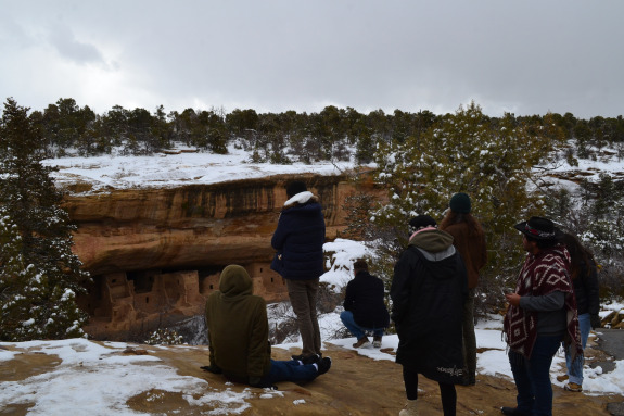 forest with snow and group of students in the foreground