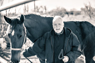 Tom Sheridan with horse black and white