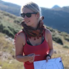 Woman in sunglasses holding pen and clipboard