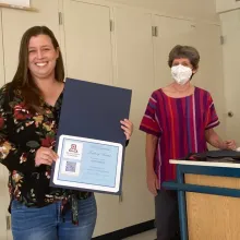 Kassi Bailey, holding award, with Diane Austin