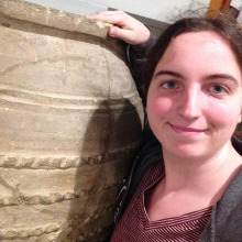 Kate Barvick standing next to a large piece of pottery