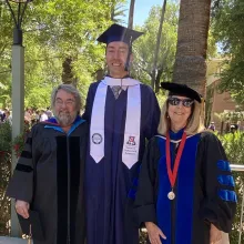 Ron Towner, Terrence Leuvano, and Barbara Mills in academic regalia