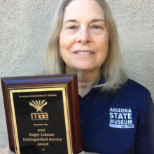 Nancy Odegaard holding award plaque