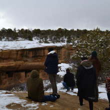 group of students view forest across a canyon