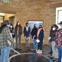 group of people in museum listening to presentation